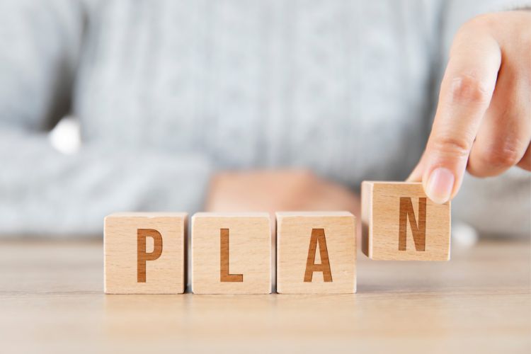 woman with blocks spelling plan