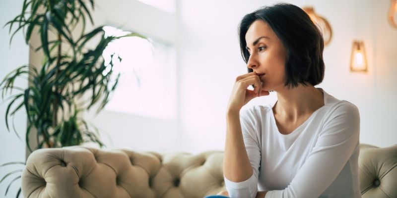 woman thinking on couch | what I reach for to feel better